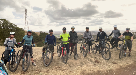 Group of mountain bike riders lined up on a cloudy day