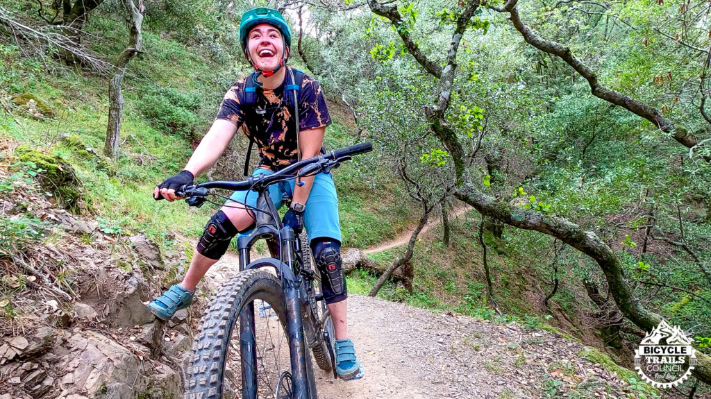 Woman smiling on mountain bike
